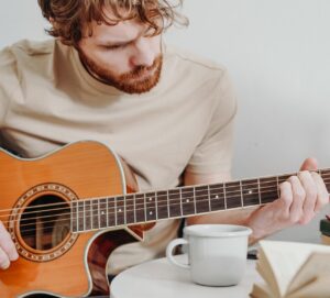 Man learning to change chords faster on guitar